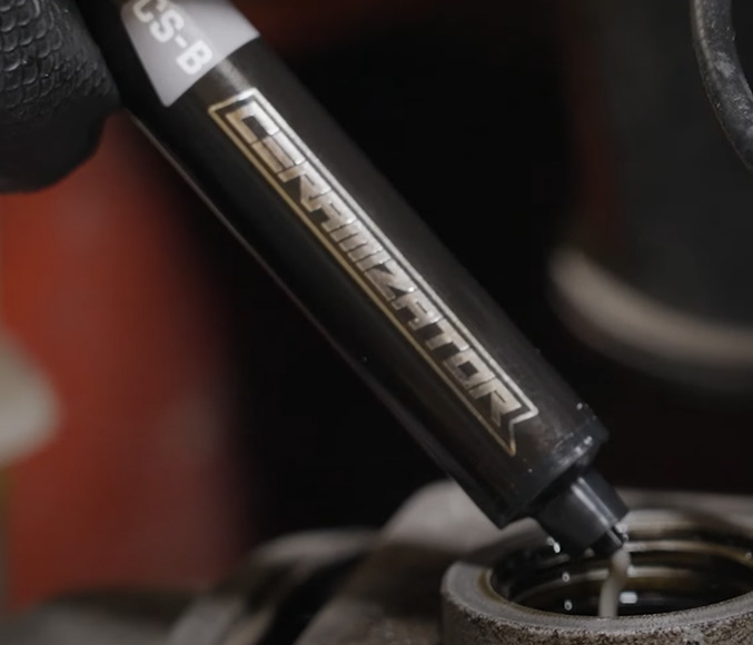 Ceramizator applicator dispensing product into an engine oil filler